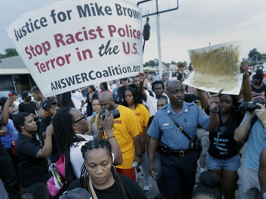photo provided by USA Today Demonstrators in Ferguson, MO call for justice in Michael Brown shooting.