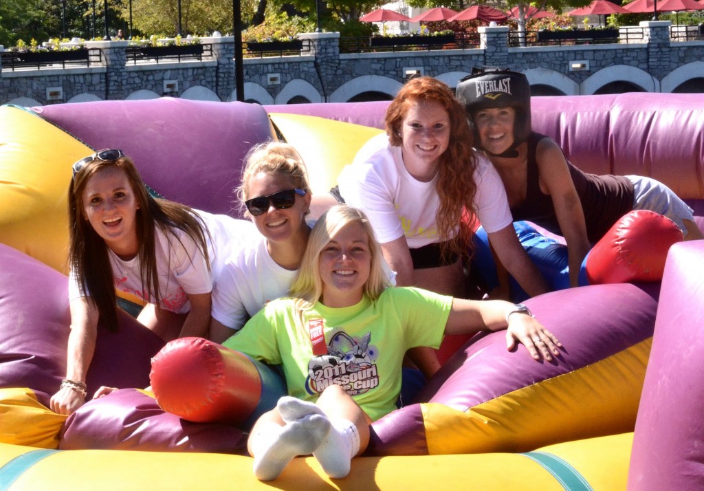 Lewis and Clark students resting after a jousting war in the bouncy pit at the 2014 Fall Fest.
