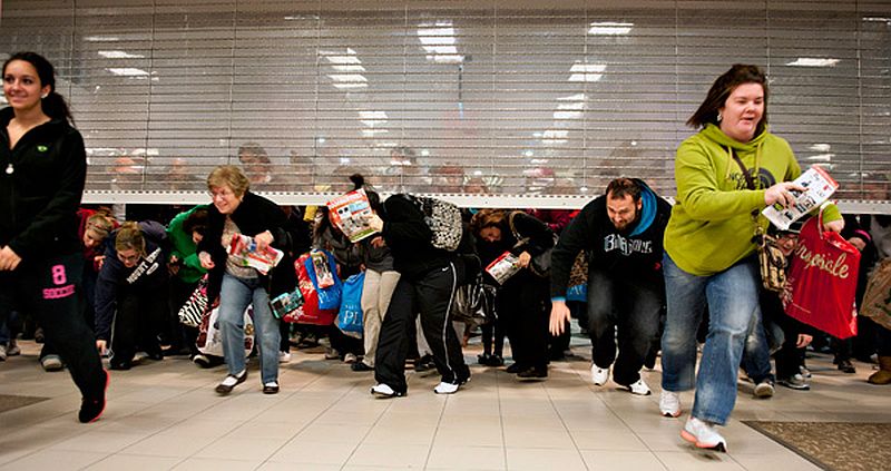 Courtesy of Businessweek.com. Customers running into the store as security gate opens.