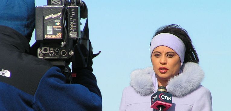 A television reporter holding a microphone in front of a cameraman from CN8 at the Petco gas explosion. (Image courtesy of Wikipedia by Jonut - Flickr.)