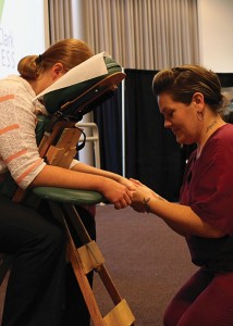Division assistant of health sciences, Amanda Mitchell, receives a chair massage from massage therapist, Stephanie Whorl.
