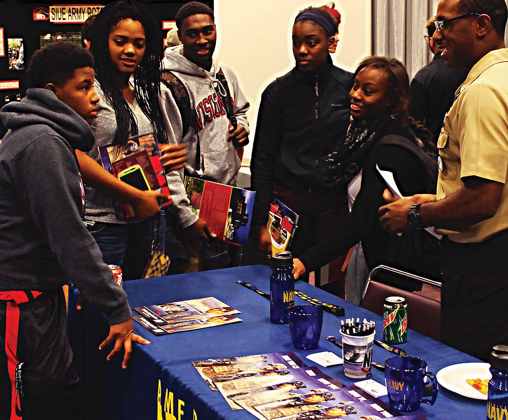 Lewis and Clark students listen to Operations Specialist, Harvest Hines give information about joining The U.S. Navy and all it has to offer at the 2014 Transfer Day.