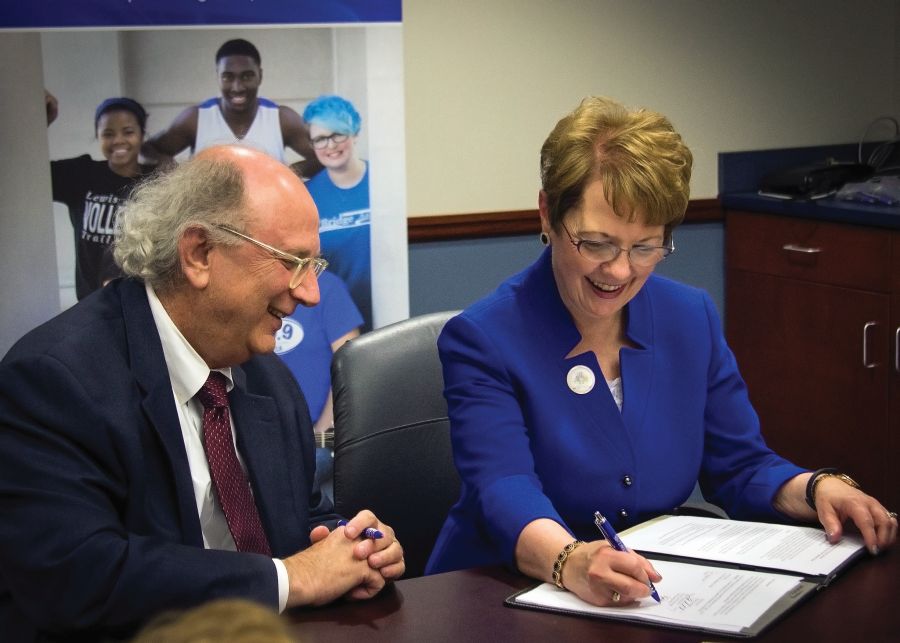 Photo by Julia Johnson  Webster University President Elizabeth Stroble signs new nursing agreement with L&C President Dale Chapman. 