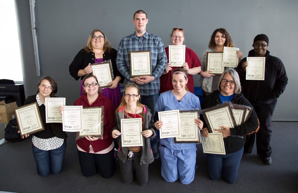 The advisor and staff of Lewis and Clark's award-winning newspaper The Bridge displaying the awards they won. Top row from left to right: Louise Jett, Donnie Becker, Krystie Morrison, Shelby Clayton, Krista Davenport. Bottom row from left to right: Helen Jarden, Kelly Rulison, Callie Logan, Hannah Auston, Karen Hancock. Photo provided by: LC Flickr