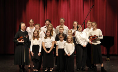 The Violin class of Sister Marie-Therese Swiezynski pose for a group picture after the recital