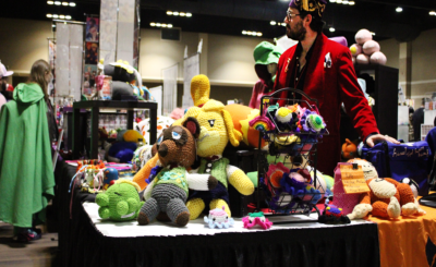 table with stuffed animals at anime convention