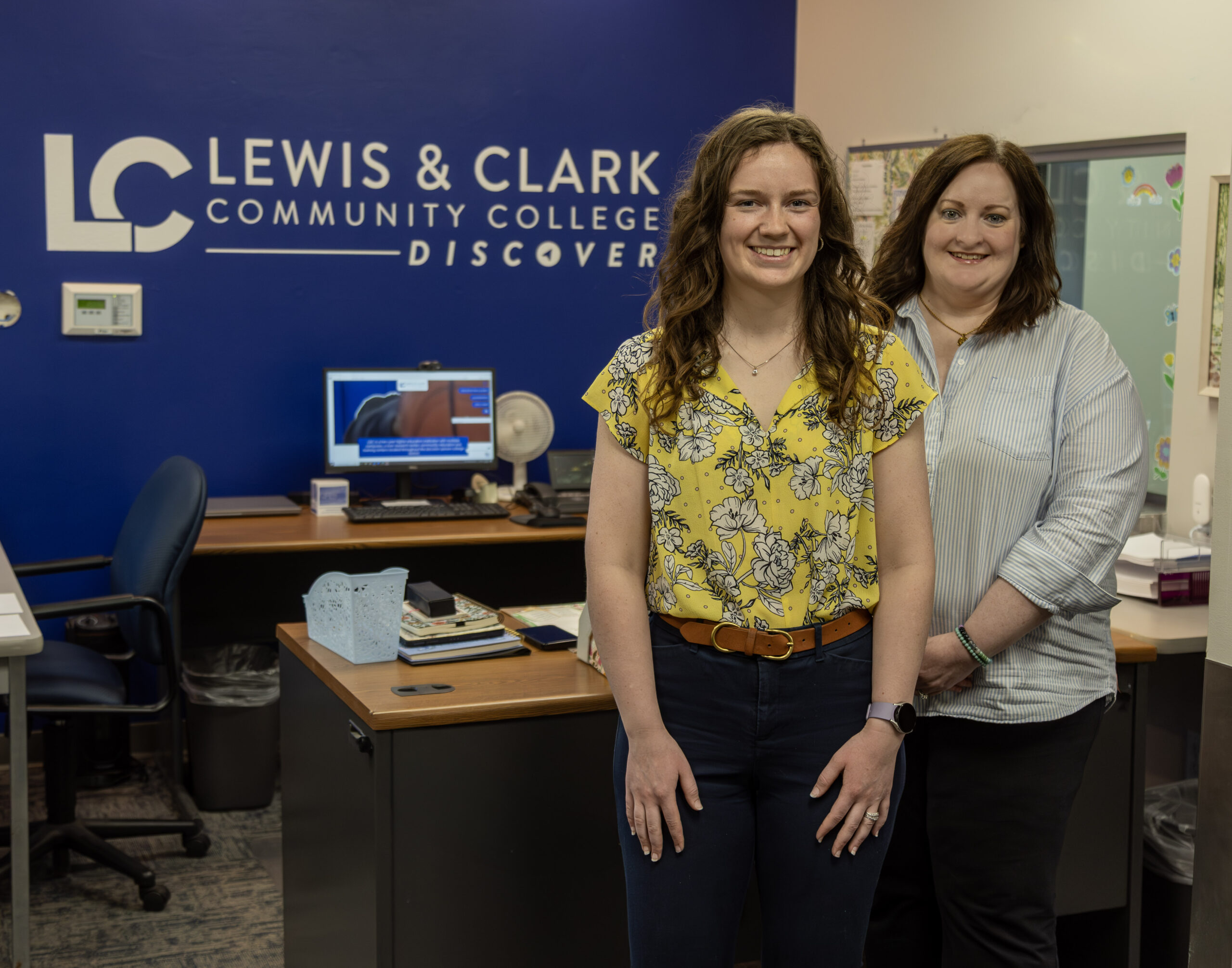 Two women stand in an office at Lewis & Clark Community College.